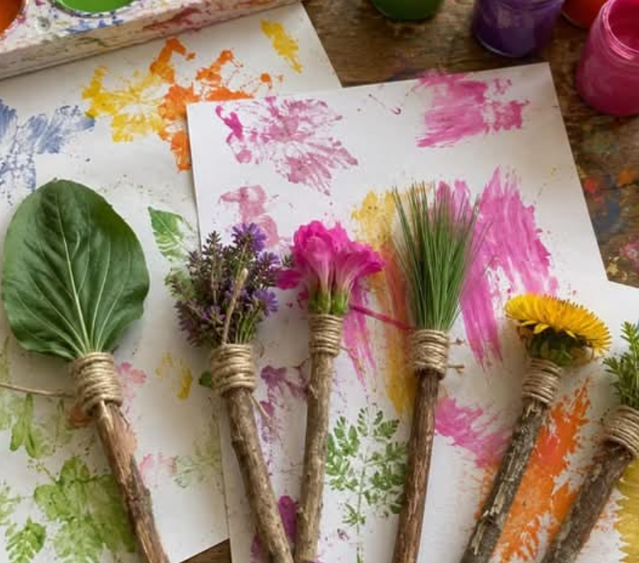 Handmade nature paintbrushes made from twigs, leaves, and flowers used for painting