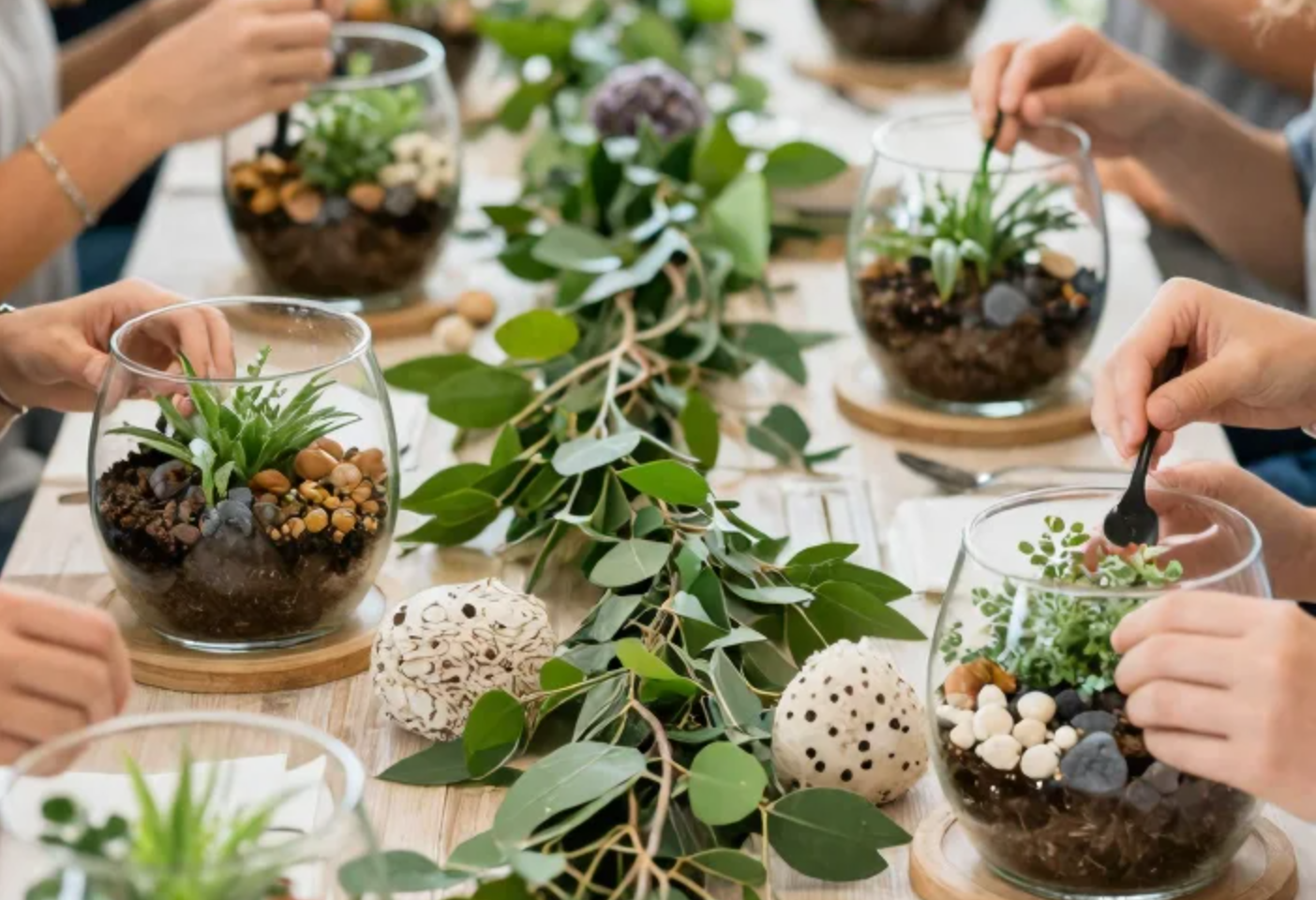 Guests building glass terrariums together at a long table
